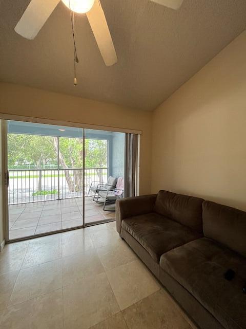 3153 Clint Moore Rd Unit 204, Boca Raton, FL 33496 - living room featuring lofted ceiling and a ceiling fan
