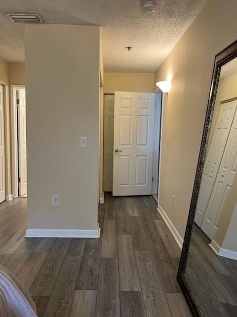 3153 Clint Moore Rd Unit 204, Boca Raton, FL 33496 - hallway with baseboards, a textured ceiling, and dark wood-style floors