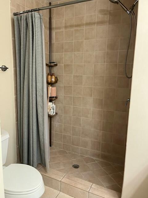 3153 Clint Moore Rd Unit 204, Boca Raton, FL 33496 - full bath featuring toilet, a shower stall, and tile patterned flooring
