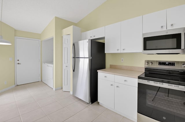 6095 Floral Lakes Dr, Delray Beach, FL 33484 - kitchen featuring stainless steel appliances, lofted ceiling, light countertops, white cabinets, and baseboards