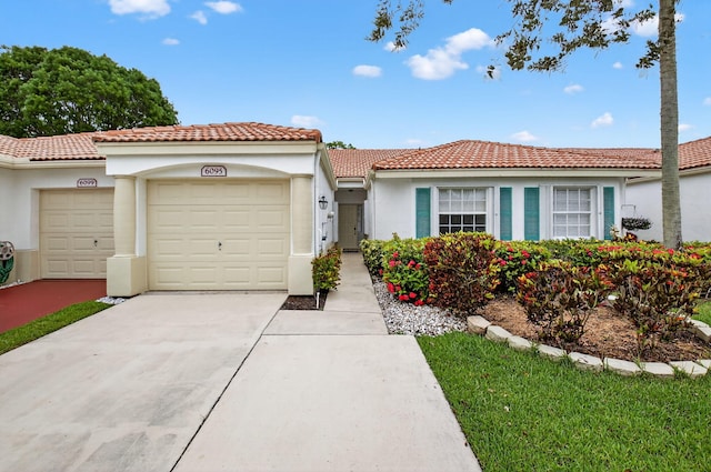 6095 Floral Lakes Dr, Delray Beach, FL 33484 - view of front of house featuring an attached garage, driveway, stucco siding, and a tile roof
