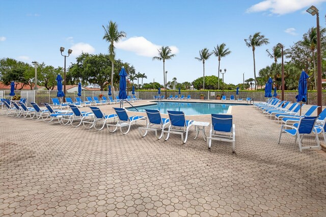 6095 Floral Lakes Dr, Delray Beach, FL 33484 - community pool featuring a patio area