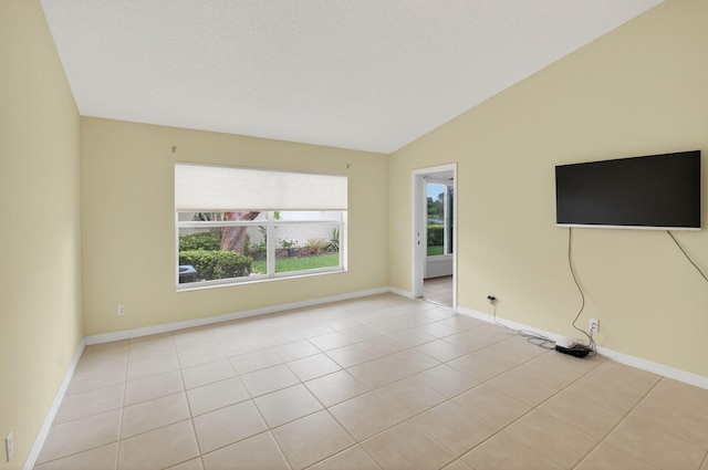 6095 Floral Lakes Dr, Delray Beach, FL 33484 - spare room with lofted ceiling, light tile patterned floors, and baseboards