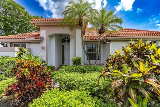 256 Eagleton Estates Blvd, Palm Beach Gardens, FL 33418 - view of front facade with a tile roof and stucco siding
