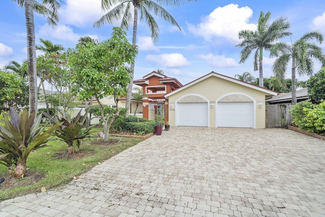 1948 Coco Palm Pl, Lauderdale By The Sea, FL 33062 - view of front of home featuring decorative driveway, stucco siding, and a garage