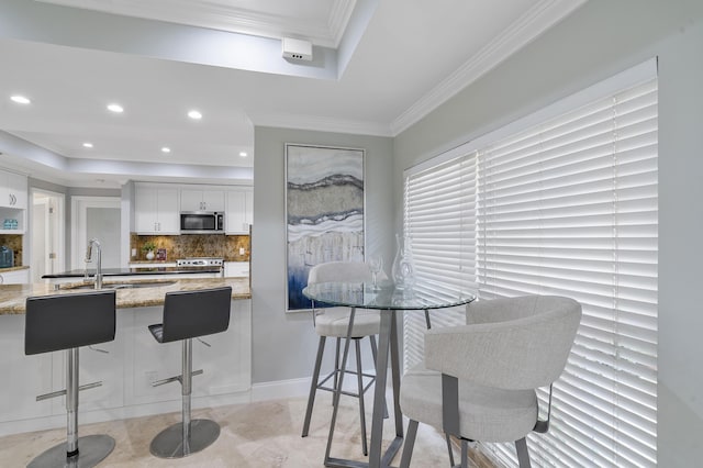 1948 Coco Palm Pl, Lauderdale By The Sea, FL 33062 - kitchen with stainless steel microwave, stove, a tray ceiling, light stone countertops, and backsplash