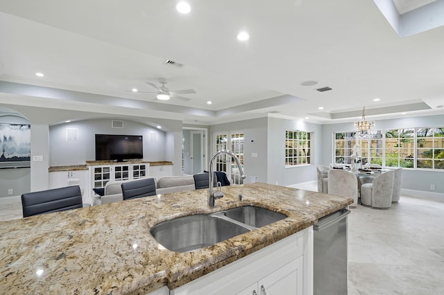 1948 Coco Palm Pl, Lauderdale By The Sea, FL 33062 - kitchen featuring a sink, a tray ceiling, light stone countertops, recessed lighting, and white cabinets