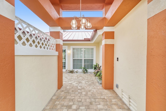 1948 Coco Palm Pl, Lauderdale By The Sea, FL 33062 - view of exterior entry featuring a standing seam roof, stucco siding, and metal roof