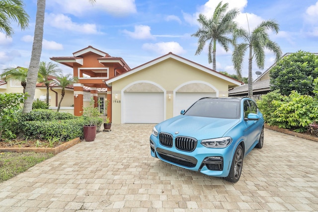 1948 Coco Palm Pl, Lauderdale By The Sea, FL 33062 - view of front of house with decorative driveway, a garage, and stucco siding