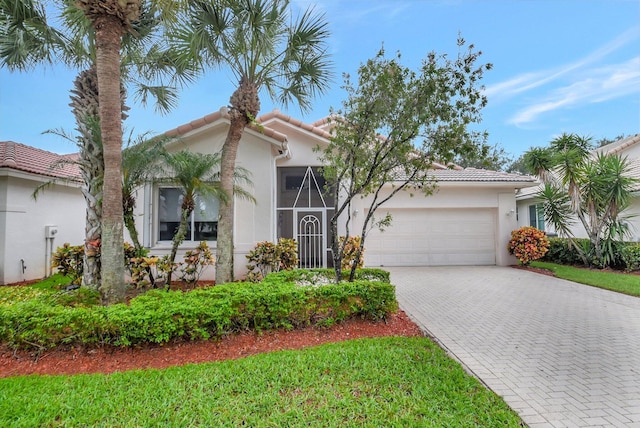 9066 Bay Harbour Cir, West Palm Beach, FL 33411 - view of front facade featuring a garage, a tiled roof, driveway, and stucco siding