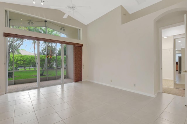 9066 Bay Harbour Cir, West Palm Beach, FL 33411 - spare room featuring light tile patterned floors, arched walkways, high vaulted ceiling, healthy amount of natural light, and a ceiling fan