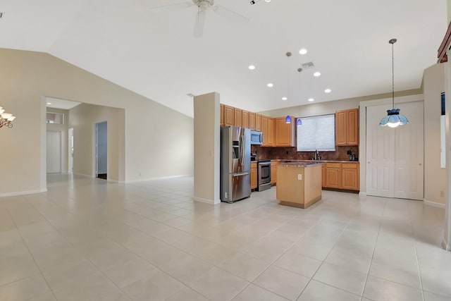 9066 Bay Harbour Cir, West Palm Beach, FL 33411 - kitchen featuring stainless steel appliances, open floor plan, lofted ceiling, a kitchen island, and a sink