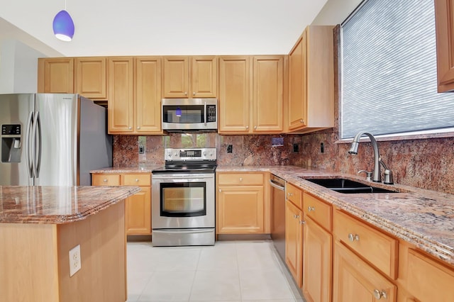 9066 Bay Harbour Cir, West Palm Beach, FL 33411 - kitchen featuring stainless steel appliances, a sink, light stone countertops, light brown cabinetry, and tasteful backsplash