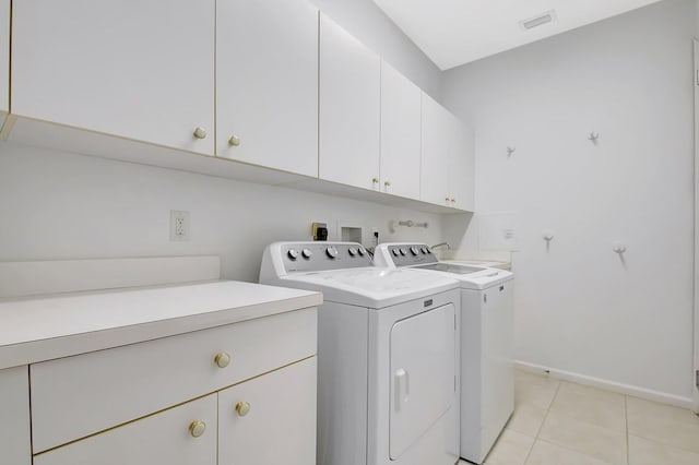 9066 Bay Harbour Cir, West Palm Beach, FL 33411 - laundry area featuring cabinet space, washing machine and clothes dryer, baseboards, and light tile patterned flooring