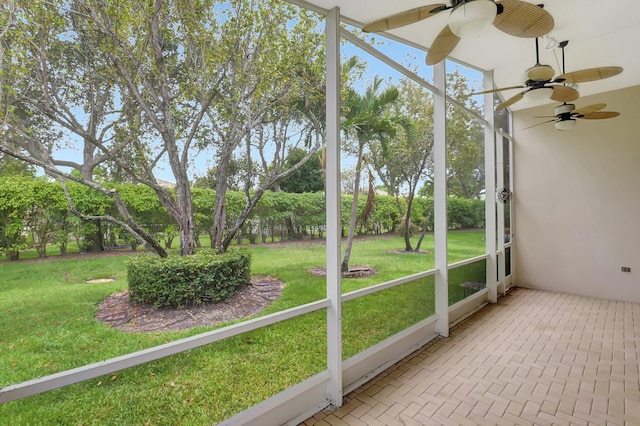 9066 Bay Harbour Cir, West Palm Beach, FL 33411 - unfurnished sunroom with a ceiling fan and view of wooded area
