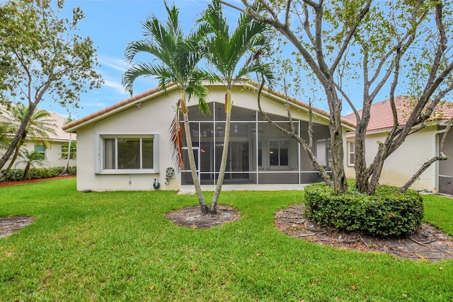 9066 Bay Harbour Cir, West Palm Beach, FL 33411 - rear view of property with a sunroom, stucco siding, a yard, and a tiled roof
