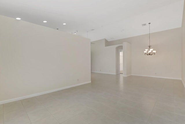 9066 Bay Harbour Cir, West Palm Beach, FL 33411 - unfurnished room with arched walkways, a chandelier, baseboards, recessed lighting, and lofted ceiling