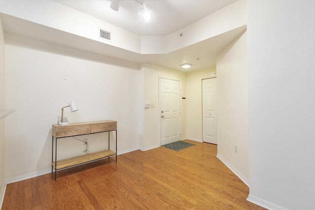 1801 N Flagler Dr Unit 107, West Palm Beach, FL 33407 - entryway featuring light wood-style floors, baseboards, and rail lighting