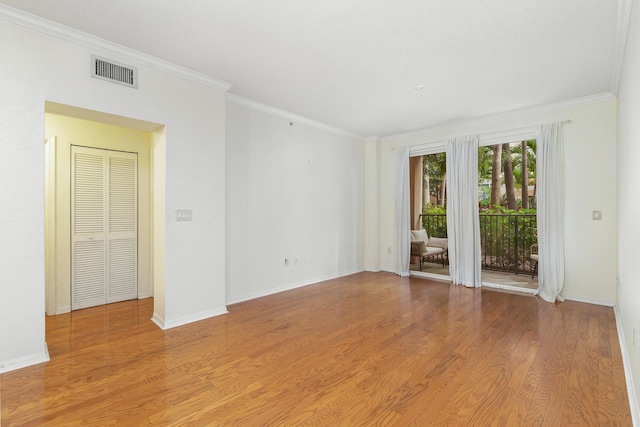 1801 N Flagler Dr Unit 107, West Palm Beach, FL 33407 - empty room featuring crown molding, light wood-style flooring, and baseboards