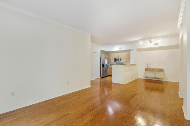 1801 N Flagler Dr Unit 107, West Palm Beach, FL 33407 - unfurnished living room with light wood finished floors, rail lighting, and baseboards