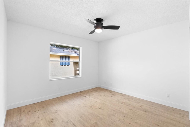6681 4th St, Jupiter, FL 33458 - empty room with wood finished floors, ceiling fan, baseboards, and a textured ceiling