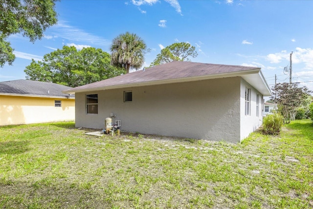 6681 4th St, Jupiter, FL 33458 - back of property with stucco siding and a yard