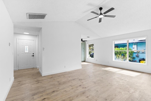 6681 4th St, Jupiter, FL 33458 - empty room featuring ceiling fan, light wood-style floors, vaulted ceiling, and a textured ceiling