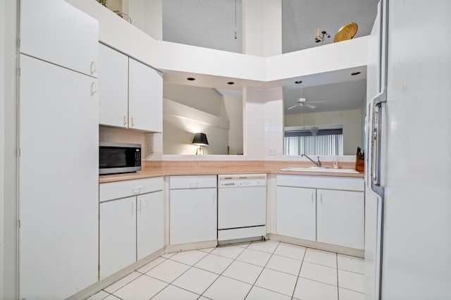 9165 Vineland Ct Unit B, Boca Raton, FL 33496 - kitchen featuring white appliances, light countertops, a towering ceiling, white cabinets, and ceiling fan