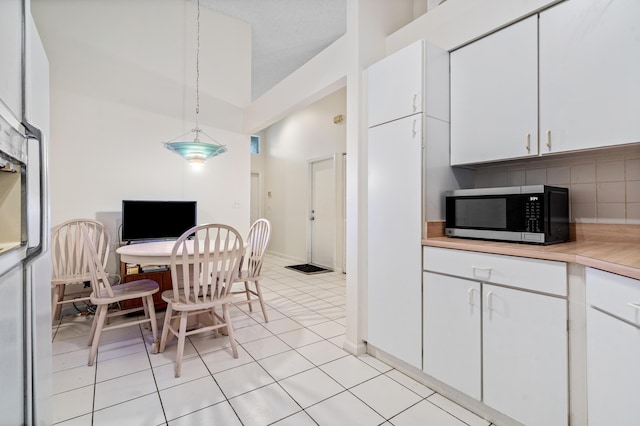 9165 Vineland Ct Unit B, Boca Raton, FL 33496 - kitchen with stainless steel microwave, white cabinets, and light countertops