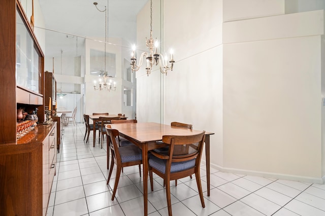 9165 Vineland Ct Unit B, Boca Raton, FL 33496 - dining area featuring a chandelier, light tile patterned flooring, and a towering ceiling