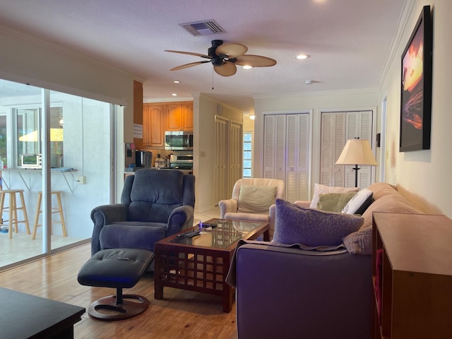 3313 Sherwood Blvd, Delray Beach, FL 33445 - living room featuring ceiling fan, light wood-style floors, ornamental molding, and recessed lighting