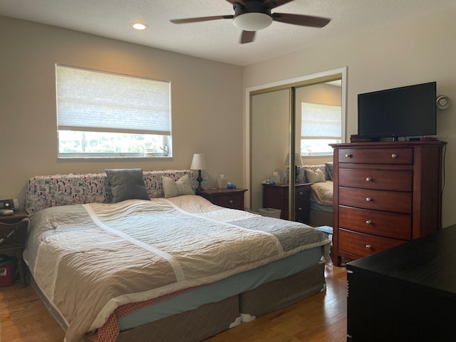 3313 Sherwood Blvd, Delray Beach, FL 33445 - bedroom with multiple windows, wood finished floors, a closet, ceiling fan, and recessed lighting