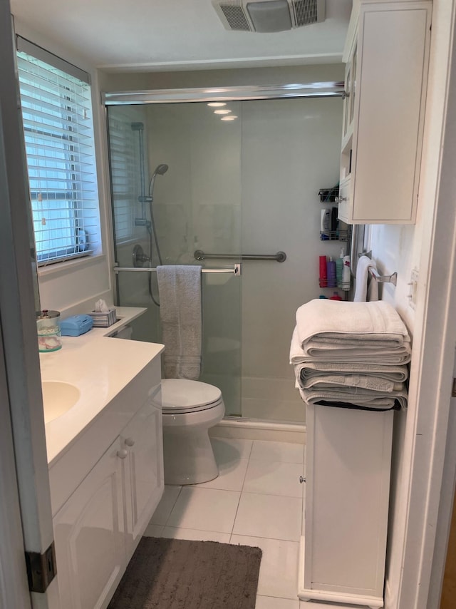 3313 Sherwood Blvd, Delray Beach, FL 33445 - bathroom featuring vanity, a shower stall, tile patterned flooring, and toilet