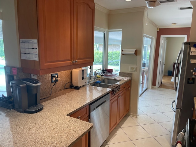 3313 Sherwood Blvd, Delray Beach, FL 33445 - kitchen featuring appliances with stainless steel finishes, a sink, light tile patterned floors, brown cabinetry, and tasteful backsplash