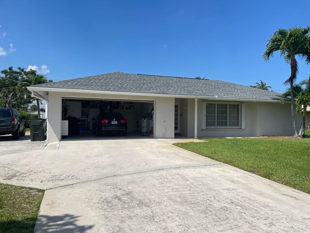 3313 Sherwood Blvd, Delray Beach, FL 33445 - ranch-style home with an attached garage, driveway, a front lawn, and stucco siding