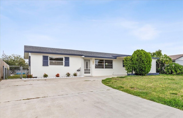 533 Riverside Dr, Palm Beach Gardens, FL 33410 - ranch-style house featuring a front lawn, stucco siding, driveway, and a gate