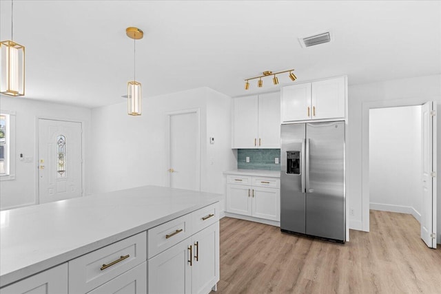 533 Riverside Dr, Palm Beach Gardens, FL 33410 - kitchen with stainless steel refrigerator with ice dispenser, white cabinetry, light wood-type flooring, backsplash, and pendant lighting