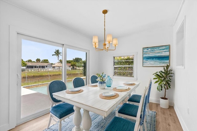 533 Riverside Dr, Palm Beach Gardens, FL 33410 - dining room featuring a chandelier and light wood-style floors