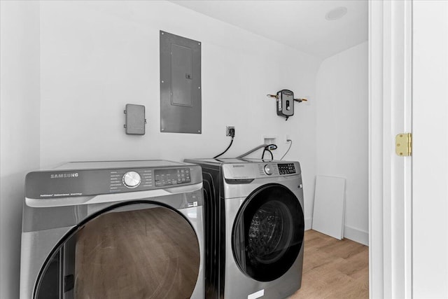533 Riverside Dr, Palm Beach Gardens, FL 33410 - laundry area featuring electric panel, separate washer and dryer, and wood finished floors