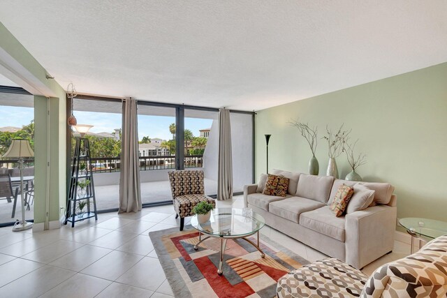 4740 S Ocean Blvd Unit 202, Highland Beach, FL 33487 - living room featuring light tile patterned flooring, floor to ceiling windows, and baseboards
