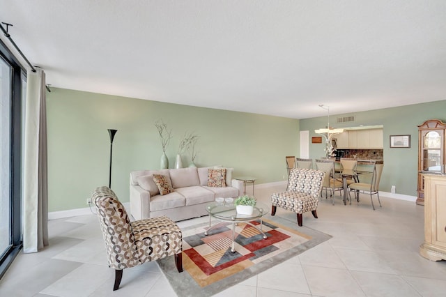 4740 S Ocean Blvd Unit 202, Highland Beach, FL 33487 - living room with baseboards, light tile patterned floors, and a chandelier
