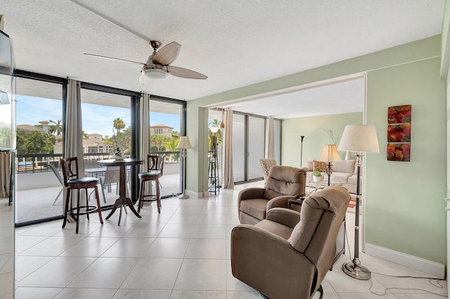 4740 S Ocean Blvd Unit 202, Highland Beach, FL 33487 - living area featuring plenty of natural light, baseboards, and a ceiling fan