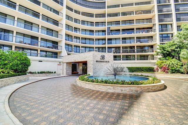 4740 S Ocean Blvd Unit 202, Highland Beach, FL 33487 - view of apartment building / complex featuring curved driveway