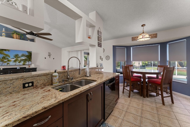 504 SW Pea Ct, Port Saint Lucie, FL 34953 - kitchen featuring a sink, black dishwasher, a textured ceiling, light stone counters, and a ceiling fan