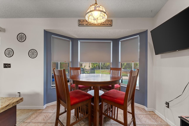504 SW Pea Ct, Port Saint Lucie, FL 34953 - dining room with a textured ceiling and baseboards
