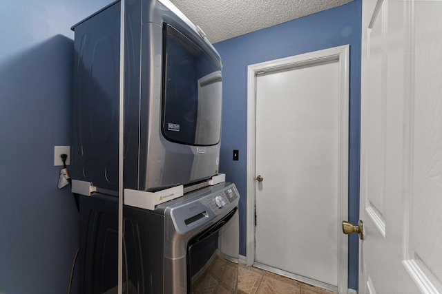 504 SW Pea Ct, Port Saint Lucie, FL 34953 - washroom with stacked washer / drying machine, a textured ceiling, and baseboards