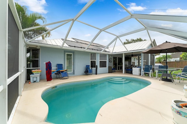 504 SW Pea Ct, Port Saint Lucie, FL 34953 - swimming pool with a patio area, ceiling fan, and a lanai