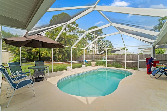 504 SW Pea Ct, Port Saint Lucie, FL 34953 - view of swimming pool featuring a fenced backyard, a patio, and glass enclosure