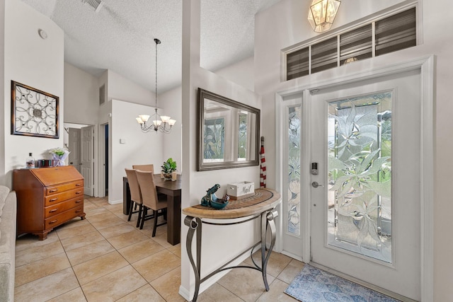 504 SW Pea Ct, Port Saint Lucie, FL 34953 - foyer entrance featuring a chandelier, light tile patterned floors, lofted ceiling, and a textured ceiling