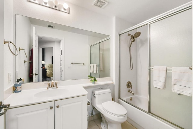 2916 Tuscany Ct Unit 104, Palm Beach Gardens, FL 33410 - bathroom featuring bath / shower combo with glass door, vanity, and toilet